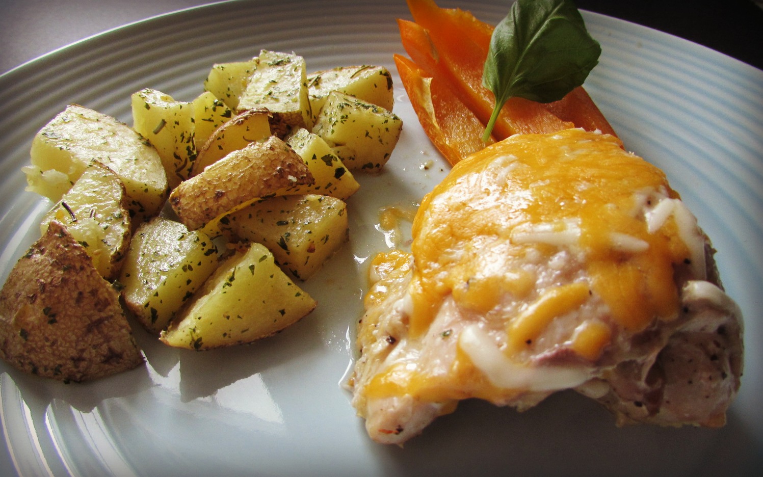 Cheesy chicken served with baked potatoes. Mmmm, good!